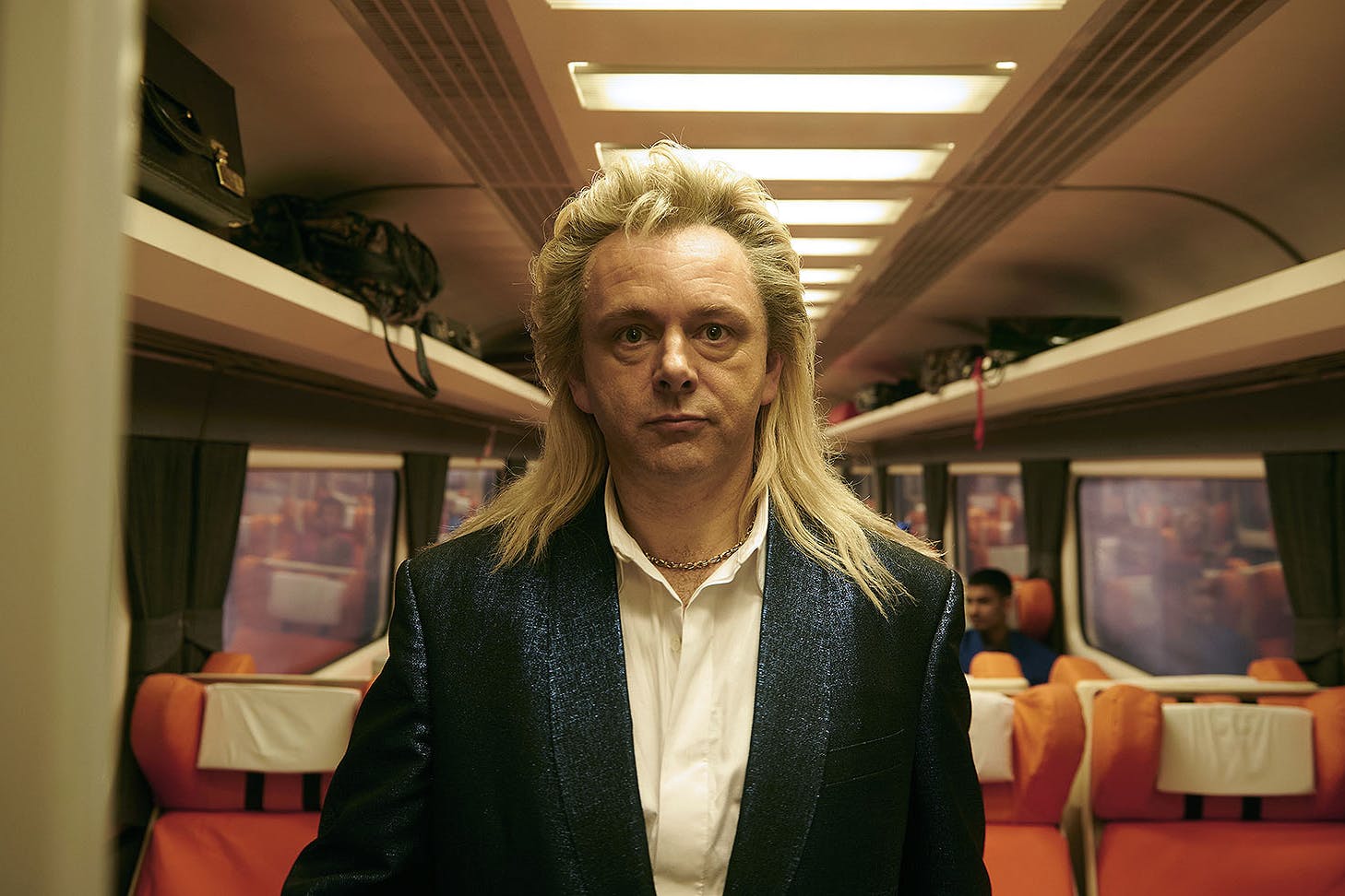 Someone stands in a train carriage looking bewildered. One of the best Christmas movies on Neon.